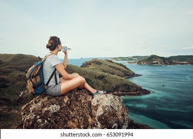 Happy Traveler With Backpack And Bottle Of Water Standing On Top Of Mountain And Enjoying Valley View With Raised Hands.
Mountains Landscape, Travel To Asia, Happiness Emotion, Summer Holiday Concept