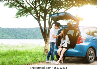 Happy Traveler Couple Sitting In Back Car And Talking About Travel