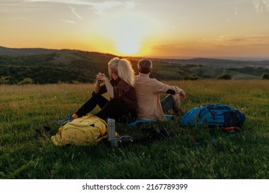 Happy traveler middle age couple resting in the mountains at sunset in spring or summer season. - Powered by Shutterstock