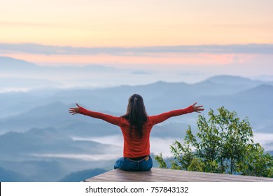 Happy traveler on mountain summit hands raised Travel Lifestyle freedom concept adventure active vacations outdoor over clouds harmony with nature