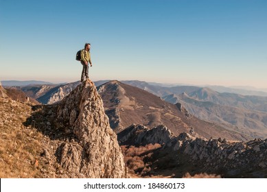 A happy traveler on a mountain top looking ahead. Active, healthy lifestyle 