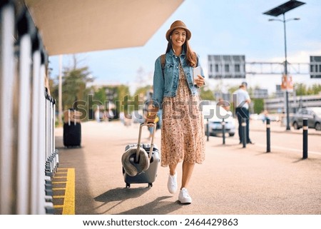 Similar – Image, Stock Photo Woman traveling with a suitcase on modern bridge