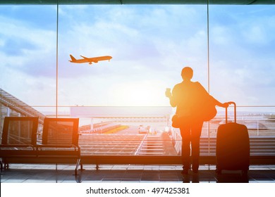 happy traveler waiting for the flight in airport, departure terminal, immigration concept - Shutterstock ID 497425381