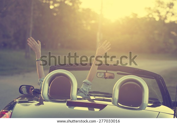 Happy traveler woman in\
cabrio car