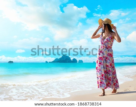 Happy traveler woman enjoys her tropical beach vacation