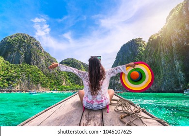 Happy traveler woman in summer dress joy fun relaxing on boat, Maya beach, Phi Phi island, Tourism Phuket, Krabi, Travel Thailand, Beautiful destination Asia, Summer holiday outdoor vacation trip
