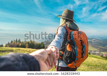Happy traveler woman tourist stay on the green grass on the peak of mountain and look on the nice fog view. Concept follow me freedom.