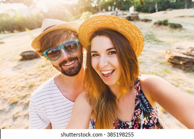  Happy Traveling Couple  Making Selfie  Mountains  Background , Sunny Summer Colors, Romantic Mood. Stylish Sunglasses, Straw Hat. Happy Laughing  Emotional Faces. 