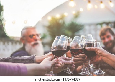 Happy Trendy Family Cheering With Red Wine At Barbecue Dinner Outdoor - Different Age Of People Having Fun At Sunday Meal - Food, Taste And Summer Concept - Focus On Old People Hands