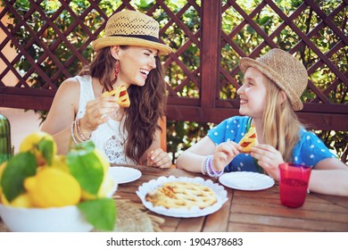 Happy Trendy Family With Crostata And Plate Of Local Farm Lemons Sitting At The Table Having Brunch In The Terrace Of Guest House Hotel.