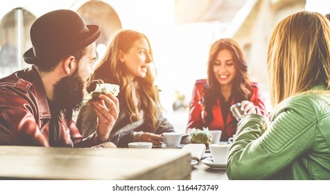 Happy Trendy People Having Breakfast Inside Bar Restaurant Patio - Young Millennials Friends Drinking Coffees And Eating Muffins In Morning Time - Fashion And Lifestyle Concept - Focus On Left Man Ear