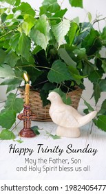 Happy Trinity Sunday. May the Father, Son and Holy Spirit bless us all - greeting card. Dove figurine, candle, birch leaves. festive traditional composition for Pentecost day