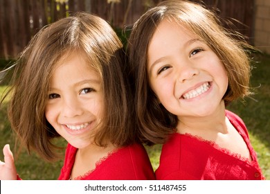 Happy twins sisters laughing - Powered by Shutterstock