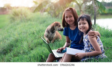 Happy Two Little Child Girl Learning Outdoor By Studying Online And Working On Laptop In The Green Farm Field