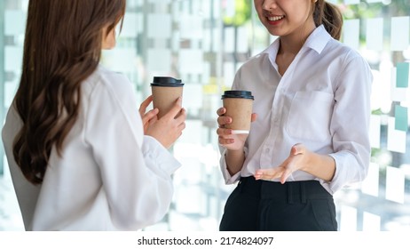 Happy Two Young Asian Business Woman Holding Coffee Cup In Office.