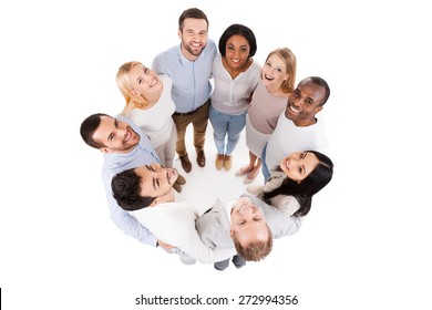 Happy United Team. Top View Of Positive Diverse Group Of Happy People In Smart Casual Wear Bonding To Each Other And Standing In Circle 