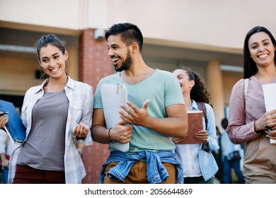 Happy university friends having fun and communicating after the lecture at campus. - Shutterstock ID 2056644869