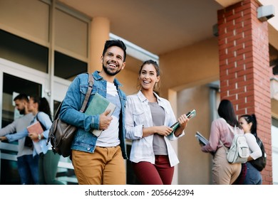 Happy university student and his female friend walking after the lecture at campus. - Shutterstock ID 2056642394