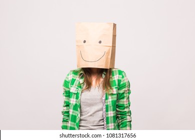 Happy unknown woman and paper bag her head white background