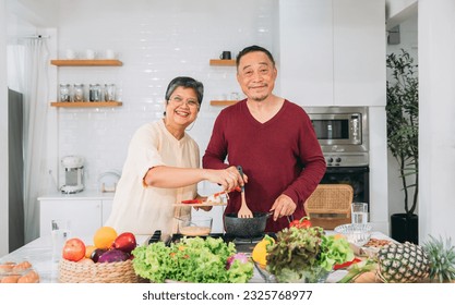 Happy Vacation Time: Elderly Couple Cooking Together in the Kitchen, Embracing Culinary Joy. Cooking Happiness of Seniors. - Powered by Shutterstock