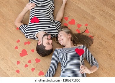 Happy valentines couple lying on the floor and looking at each other. Top view, toned. - Shutterstock ID 1286271850
