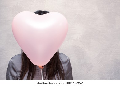 Happy Valentines Day Concept. Balloon In The Shape Of A Heart And A Girl With Long Dark Hair. No Face Concept.