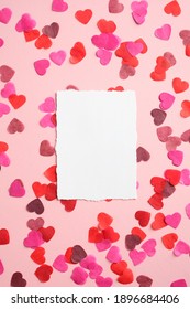 Happy Valentines day concept. Blank paper card and hearts on pink background. Valentine's day greeting card mockup, gift voucher or romantic wedding invitation design.