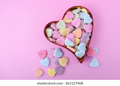 Happy Valentines Day Conversation Heart Candy In Red Heart Shaped Gift Box On Pink Background, With Copy Space.