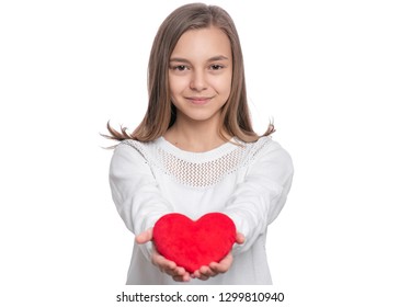 Happy Valentines Day. Cute Young Teen Girl In Love With Red Plush Heart In Her Hands. Smiling Child Looking At Camera, Isolated On White Background.