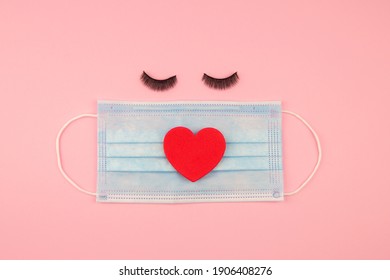 Happy Valentines Day During Corona Pandemic - Cute Blue Protective Medical Mask With Heart And Eyelashes On Pink Background 