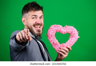 Happy Valentines Day. Hipster Hold Heart Symbol Love. Romantic Surprise. Man Formal Suit Celebrate Valentines Day Green Background. Spread Love Around. Happy In Love. Romantic Macho Flirting