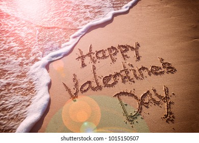 Happy Valentine's Day message handwritten on smooth sand beach with incoming wave
 - Shutterstock ID 1015150507