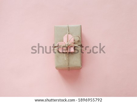 Happy Valentine's Day photography with gift box and paper origami heart on natural background. Romantic greeting card. 