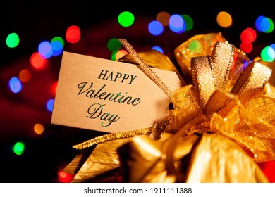 Happy Valentines Day - Text On A Gift Box Label With A Large Gold Bow. 