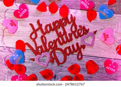 Happy Valentines Day text on red wooden surface surrounded by colorful hearts - Powered by Shutterstock