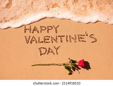 Happy Valentine's Day written on sand beach and red rose. Valentines day background concept.  - Shutterstock ID 2114918510