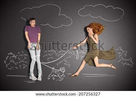 Happy valentines love story concept of a romantic couple against chalk drawings background. Male entrapped into to the leash by a cute puppy. 