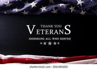 Happy Veterans Day. American flag on black background with text Thank you veterans..
