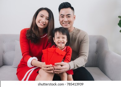 Happy Vietnamese Family Celebrate Lunar New Year At Home.