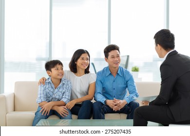 Happy Vietnamese Family Of Three At The Meeting With Real Estate Broker