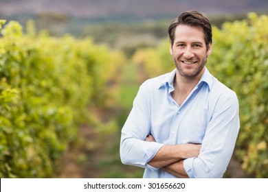 Happy vintner with crossed arms in the fields - Powered by Shutterstock