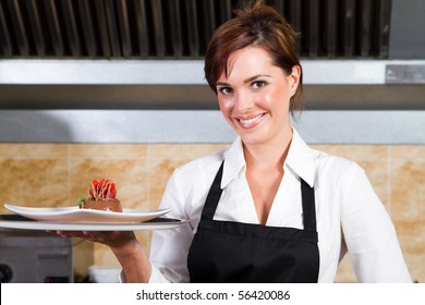 happy waitress holding plate of dessert - Powered by Shutterstock