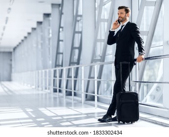 Happy Wealthy Businessman Standing In Airport, Talking On Mobile Phone With Business Partners Or Family And Looking Through The Window, Waiting For Departure, Travelling For Work Abroad, Copy Space