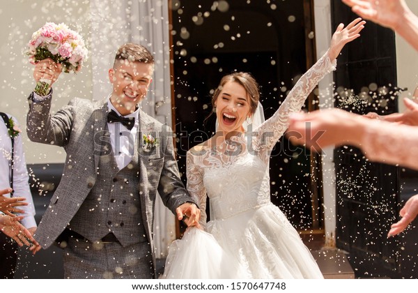 Happy wedding\
photography of bride and groom at wedding ceremony. Wedding\
tradition sprinkled with rice and\
grain