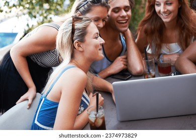 Happy, weekend and friends with laptop at a restaurant for a meme, social media or funny video. Laughing, group and men and women with a computer at an outdoor cafe for conversation or comedy online - Powered by Shutterstock