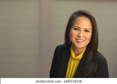 Happy Well Dressed Mature Asian Woman Smiling.