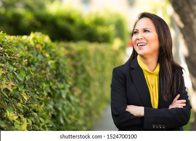 Happy Well Dressed Mature Asian Woman Smiling And Looking To The Side Of The Frame.