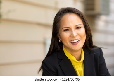 Happy Well Dressed Mature Asian Woman Smiling.