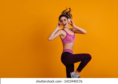 Happy white girl enjoying zumba. Indoor photo of dancing fitness woman. - Powered by Shutterstock