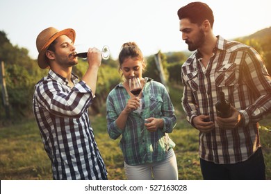 Happy wine tourists tasting wine in vineyard - Powered by Shutterstock